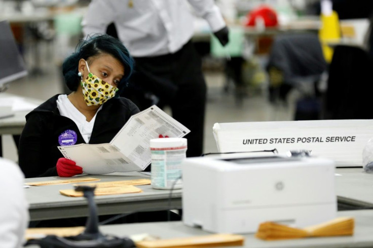 Detroit election workers count absentee ballots at TCF Center on November 4, 2020