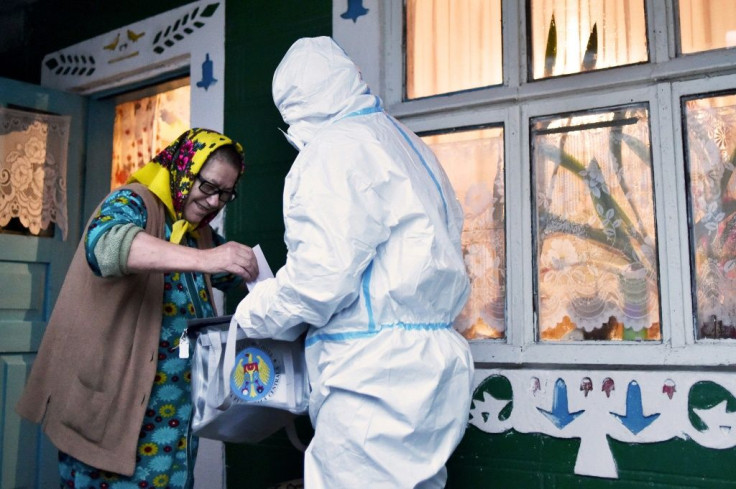 Elections workers in anti-virus gear brought mobile ballot boxes to voters for the first round presidential vote this month