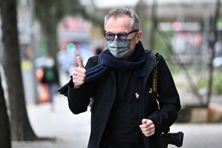 Swiss photographer Marc Progin, 75, had been charged with 'aiding and abetting public disorder'