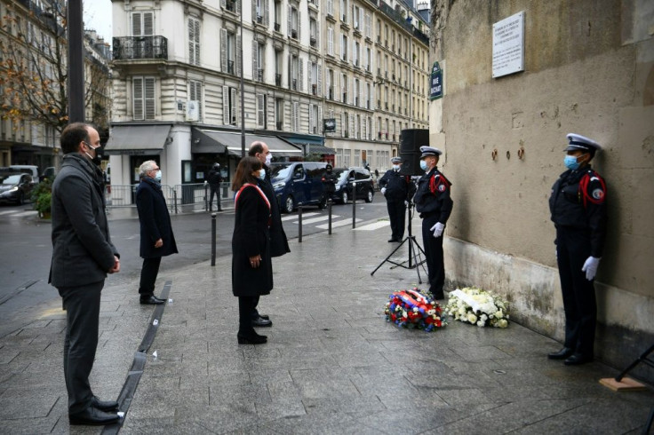 Paris Mayor Anne Hidalgo (C) and French Prime Minister Jean Castex paid tribute outside Le Carillon bar and Le Petit Cambodge restaurant during ceremonies across Paris