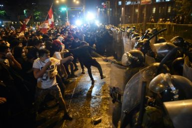 Demonstrators confront riot police during a protest in Lima against the ousting of popular president Martin Vizcarra by Congress