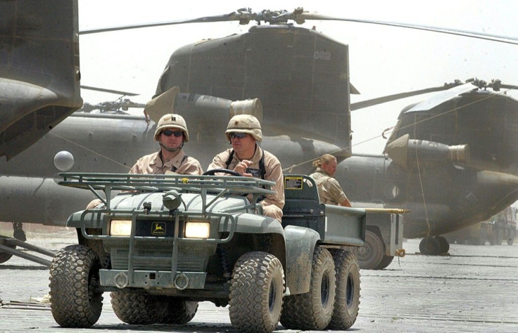 US soldiers drive past Chinook helicopters in 2002, a year after the invasion of Afghanistan at Bagram Air Base, which has become a center of US military power after nearly two decades of war