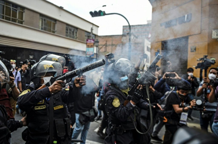 Riot police fire  tear gas as they try to disperse supporters of ousted Peruvian president Martin Vizcarra in Lima, November 2020