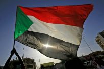 A Sudanese protester waves a national flag in the capital Khartoum in June 2020