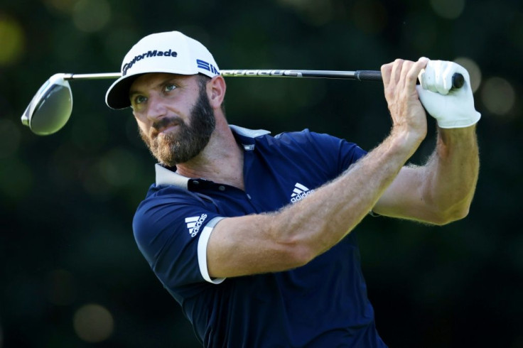 World number one Dustin Johnson closed with a birdie to grab a share of the clubhouse lead Friday in the second round of the 84th Masters
