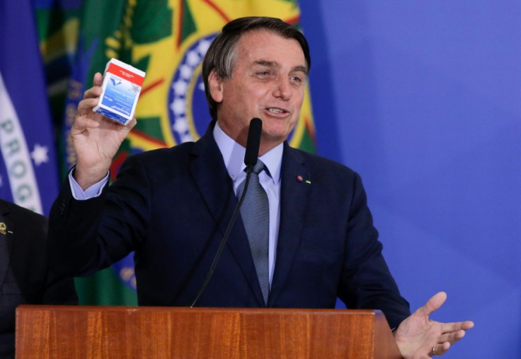 Brazilian President Jair Bolsonaro holds a hydroxychloroquine box as he speaks in Brasilia in September 2020