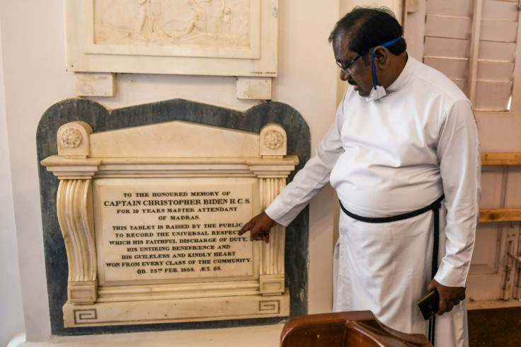 A pastor shows a memorial tablet for Christopher Biden, born in 1789, at St George's Cathedral in Chennai