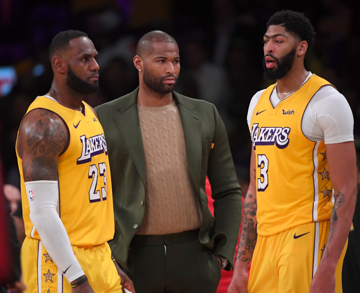  LeBron James #23 and Anthony Davis #3 talk with DeMarcus Cousins #15 of the Los Angeles Lakers
