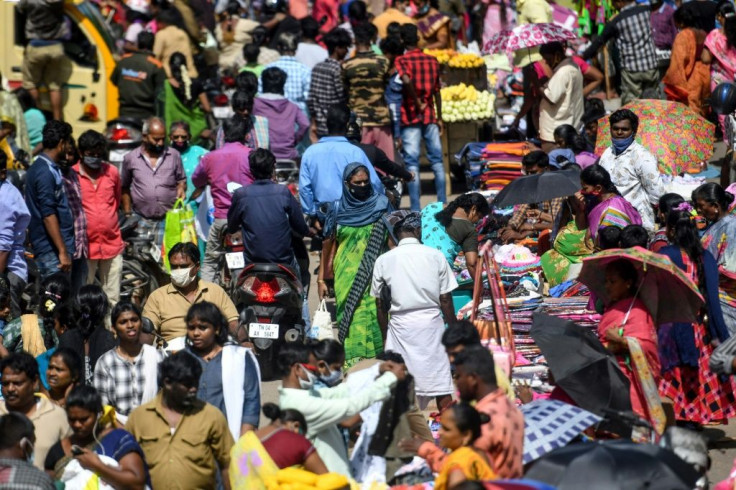 People gather for shopping at a market ahead of Diwali