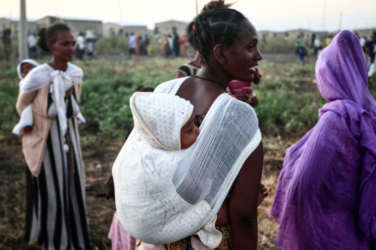 Over 20,000 Ethiopians have fled as refugees into Sudan, with numbers continuing to grow, including these families photographed on November 13