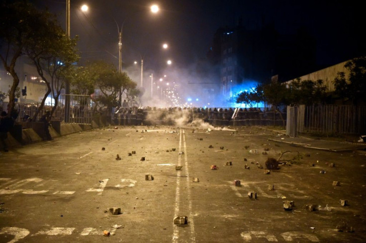 Riot police take position during clashes with supporters of ousted Peruvian president Martin Vizcarra in Lima