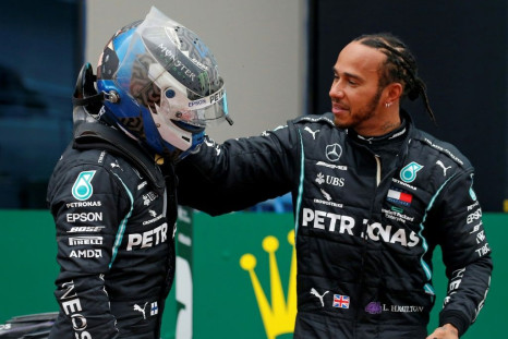 Lewis Hamilton is congratulated by Mercedes teammate Valtteri Bottas after winning a seventh drivers' crown