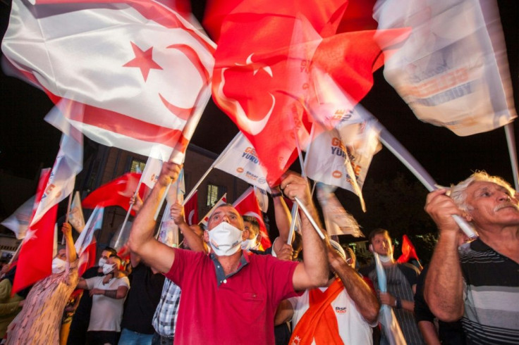 Supporters of right-wing nationalist Ersin Tatar celebrate his win in the election in the self-proclaimed Turkish Republic of Northern Cyprus on October 18