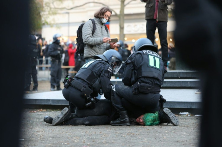 Demonstrations against the restrictions were held on Saturday across Germany, including one in Frankfurt where police used water cannon and detained protesters