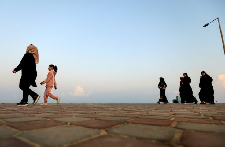 Palestinians walk on the beachfront of the Gaza Strip in a bid to escape the confinement of coronavirus restrictions -- which come on top of the Israeli blockade of the enclave