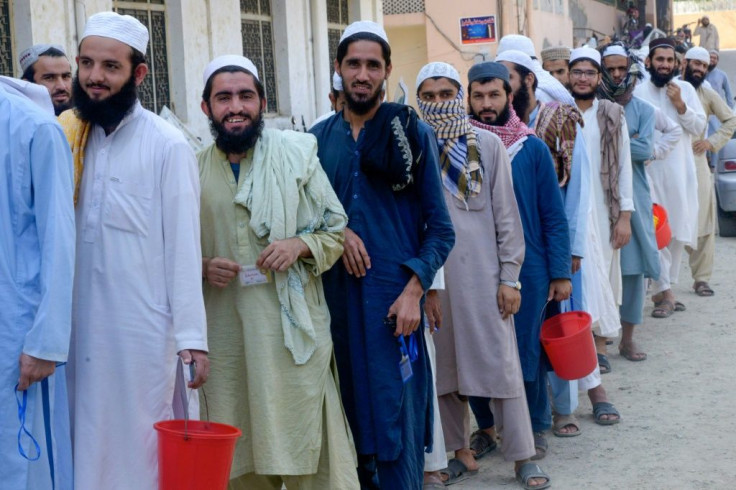 Students wait to collect food at the Darul Uloom Haqqania seminary