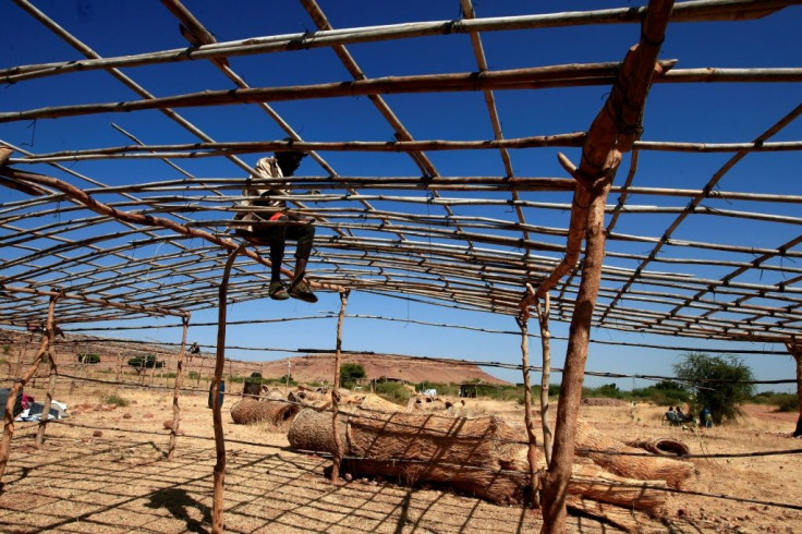 Some refugees are erecting their own basic tents as workers are rushing to build acccommodation