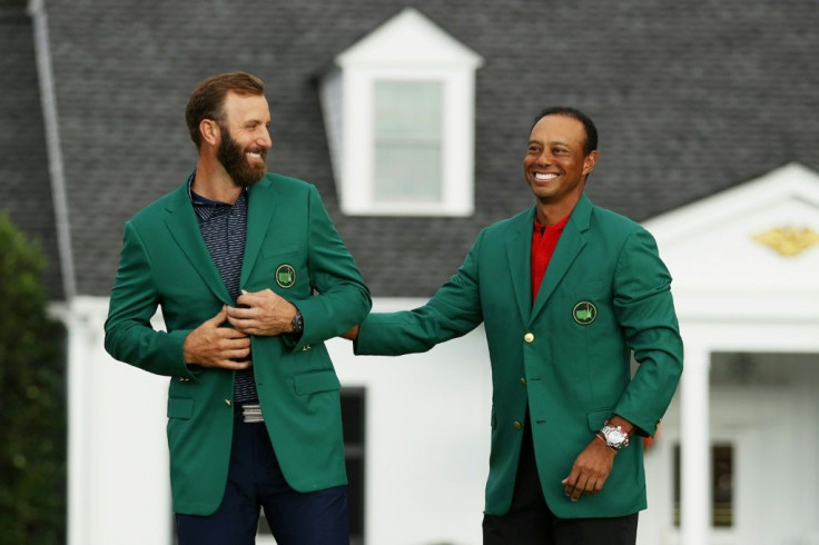 Dustin Johnson has the 2020 Masters green jacket placed on him by 2019 champion Tiger Woods