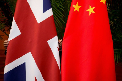 Beijing has praised a British diplomat who was filmed diving into a river in southern China to save a drowning student