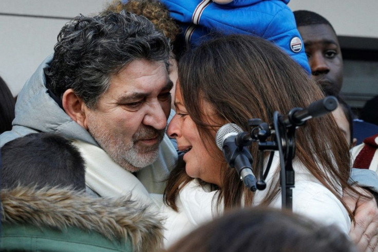 The parents of a delivery driver who died during his arrest by French police last May are seen here grieving at a rally for him in Paris.