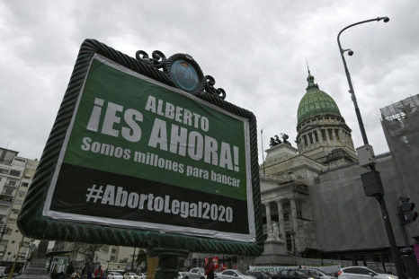 An advert asking President Alberto Fernandez to present a new bill to legalize abortion, pictured outside the Argentine Congress building in Buenos Aires, in October 2020