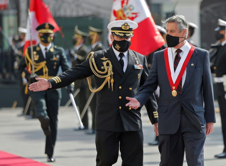 Newly appointed Peruvian interim President Francisco Sagasti is scorted by a military attache upon his arrival at the Congress building in Lima on November 17, 2020, for his swearing-in ceremony