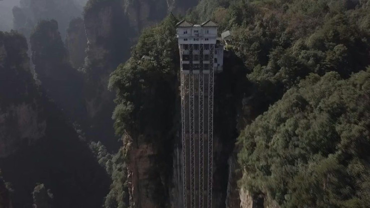 Towering 326 metres up the cliff face which inspired the landscape for the blockbuster movie "Avatar", races the world's highest outdoor elevator, whisking brave Chinese tourists to breathtaking views.The three double-decker elevators in central China'