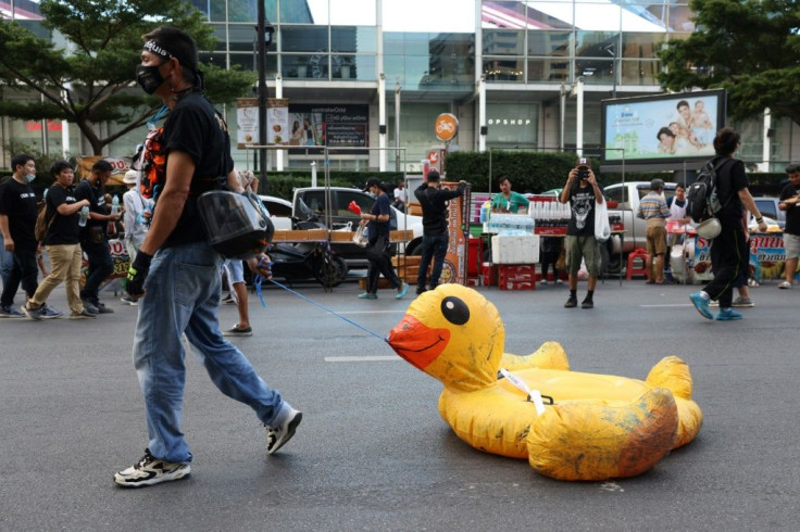 A pro-democracy protester walks with an inflatable duck during an anti-government rally in Bangkok on November 18, 2020