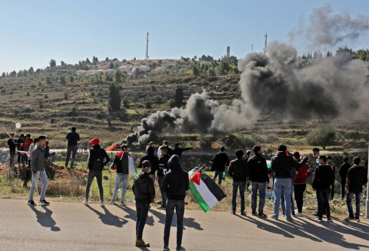 Palestinians demonstrate near the Israeli settlement of Psagot, built on the lands of the city of al-Bireh, against the visit by Pompeo to the settlement in the occupied West Bank