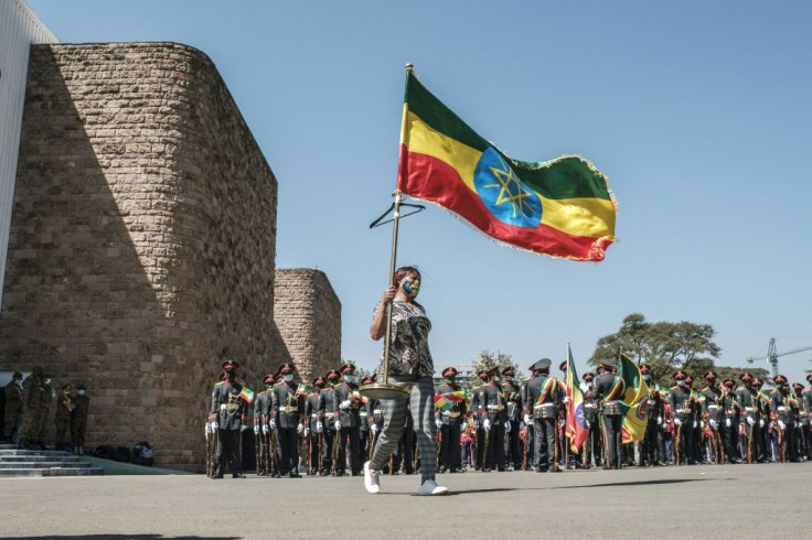 A woman carries an Ethiopian national flag in ceremonies at the prime minister's compound in Addis on Wednesday to honour the armed forces