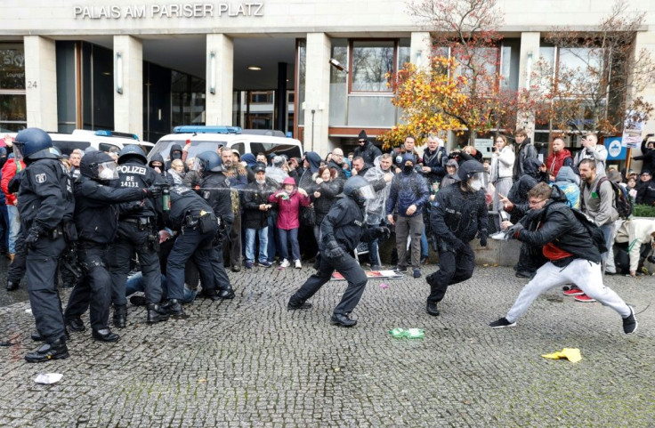 Police in Berlin fired water cannon on Wednesday to disperse thousands of unmasked protesters.