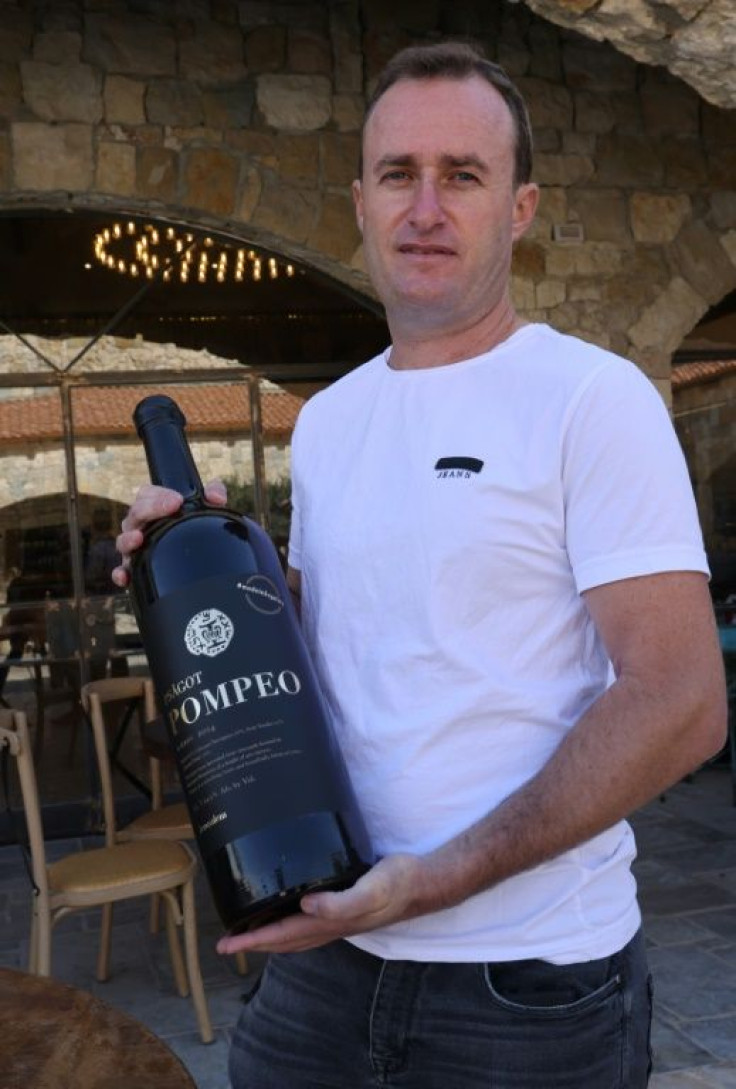 An Israeli winemaker holds a bottle of his red blend named after US Secretary of State Mike Pompeo at the Psagot Winery in the occupied West Bank