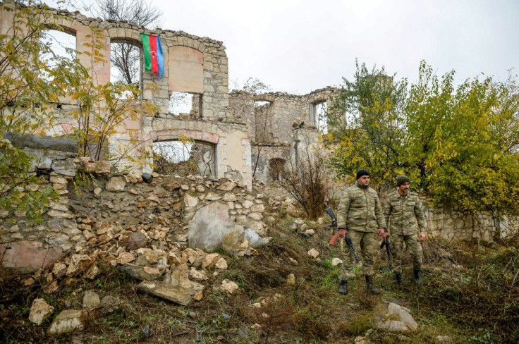 An Azerbaijani flag was freshly hoisted on the roof of a house half destroyed by artillery fire in Fizuli