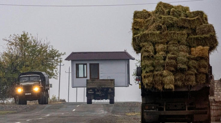 A truck carries a barn as Armenian refugees leave the village of Nor Maragha near Agdam