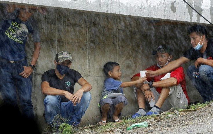 People take refuge under La Democracia bridge while waiting for relatives to be rescued from floods caused by the passage of Hurricane Iota in El Progreso, Yoro department, Honduras