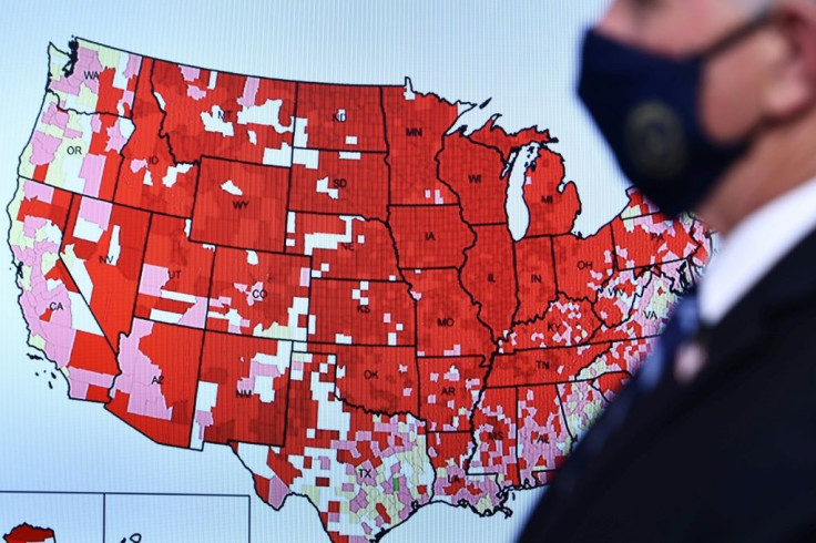 Vice President Mike Pence stands by a Covid-19 map during a White House Coronavirus Task Force press