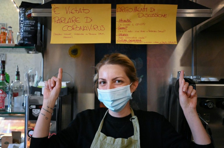 Cristina Mattioli, manager of the Feeling bar, put up one poster banning virus talk and another offering other ideas for conversation.
