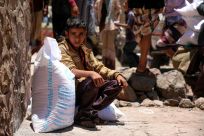 A Yemeni boy receives aid donated by the World Food Programme (WFP) in the country's third city of Taez, in October 2020 -- UN chief Antonio Guterres warns Yemen is in imminent danger of the worst famine the world has seen in decades