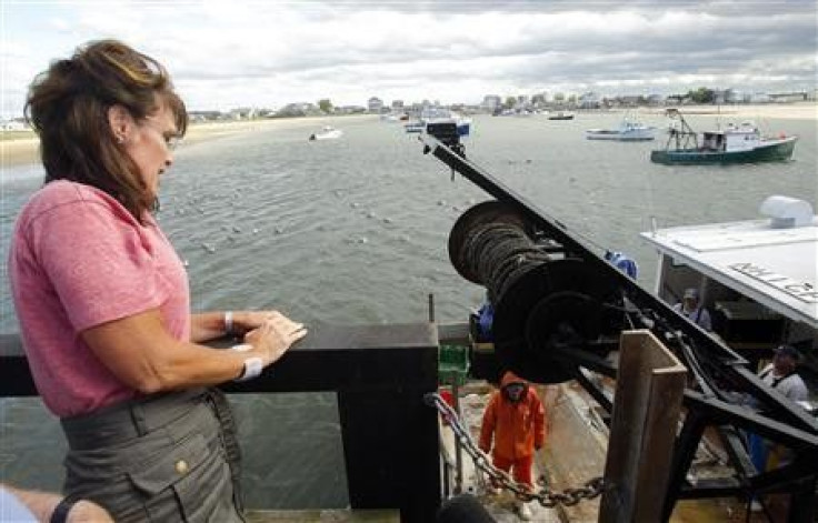Former Alaska governor Sarah Palin (L) watches fishermen unload their catch at Yankee Seafood Cooperative in Seabrook, New Hampshire June 2, 2011.