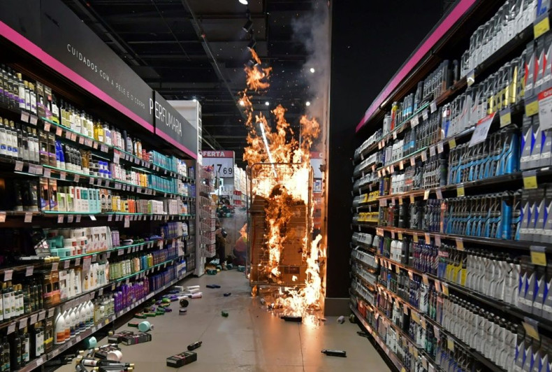 Products burn at a supermarket Carrefour in Sao Paulo, Brazil, on November 20, 2020 after protesters stormed it during a demonostration against racism and the death of a black man beaten by white security agents