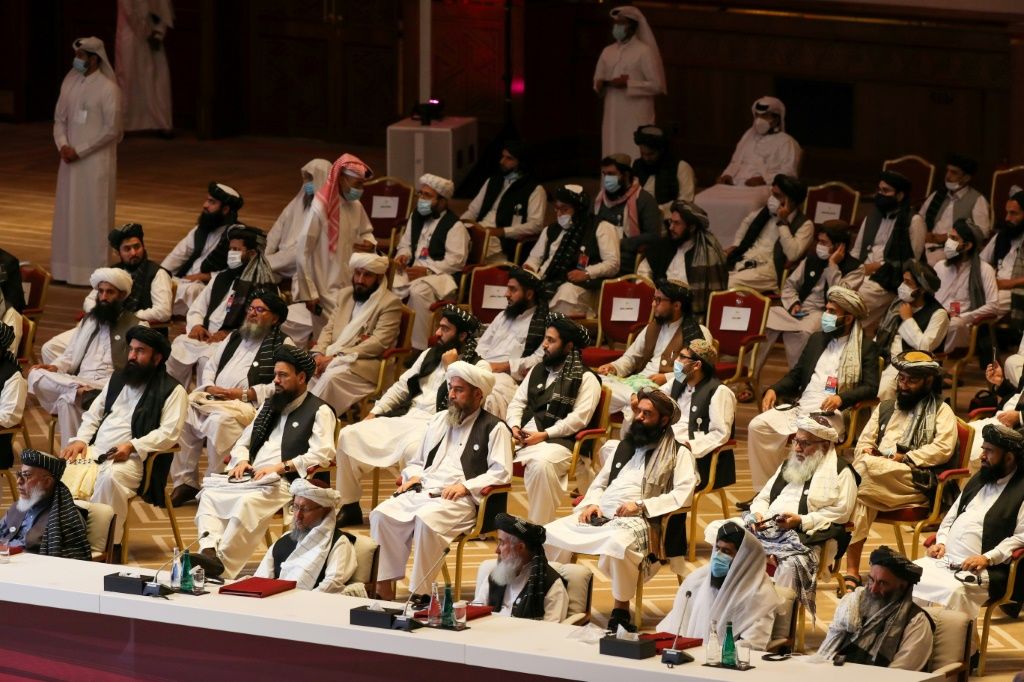 Peace talks between the Afghan government and the Taliban opened in September in Doha here Taliban delegates listen during the opening session
