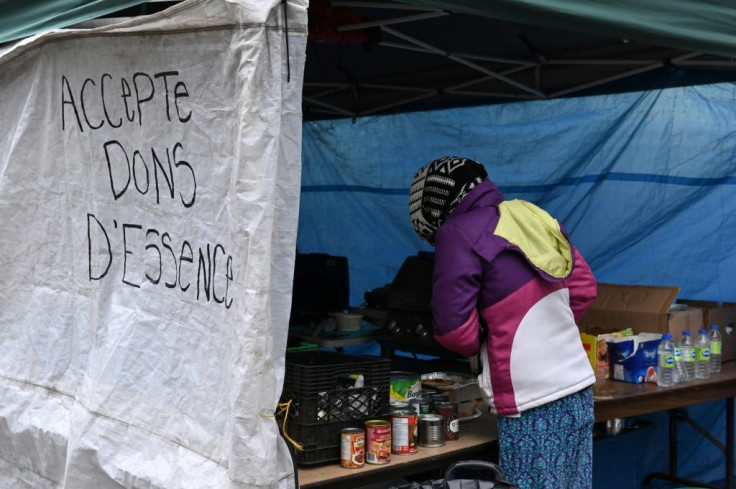 A makeshift kitchen, with a sign that reads, "Fuel donations accepted," offers free food donated by charities and neighbors at a Montreal homeless camp set up in the summer of 2020