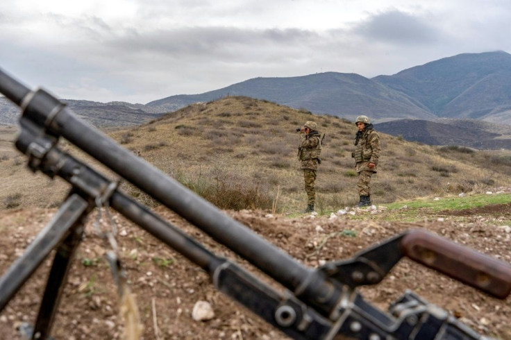 Armenian soldiers patrol a check point near a demarcation line outside Askeran