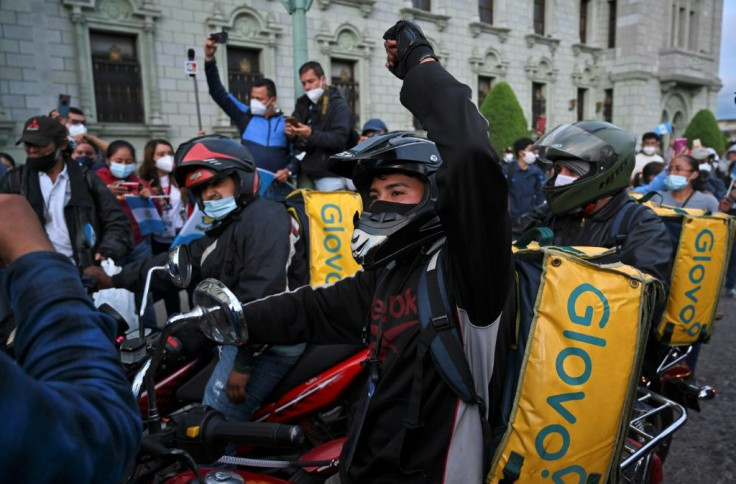 Food delivery couriers take part in a protest demanding the resignation of Guatemalan President Alejandro Giammattei, in Guatemala City on November 22, 2020