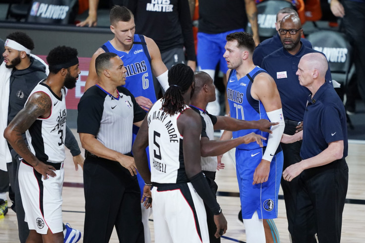 Officials get between Luka Doncic #77 of the Dallas Mavericks and Marcus Morris Sr. #31 of the LA Clippers