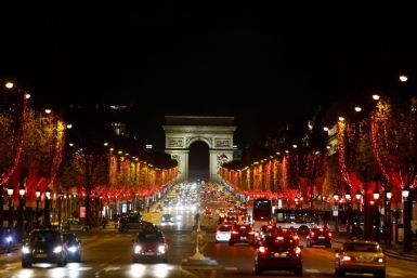 The Champs Elysees in Paris is illuminated in red for the Christmas period, as Europe and the Americas battle rising coronavirus caseloads that are pushing health systems to the brink, forcing governments to issue stay-at-home orders