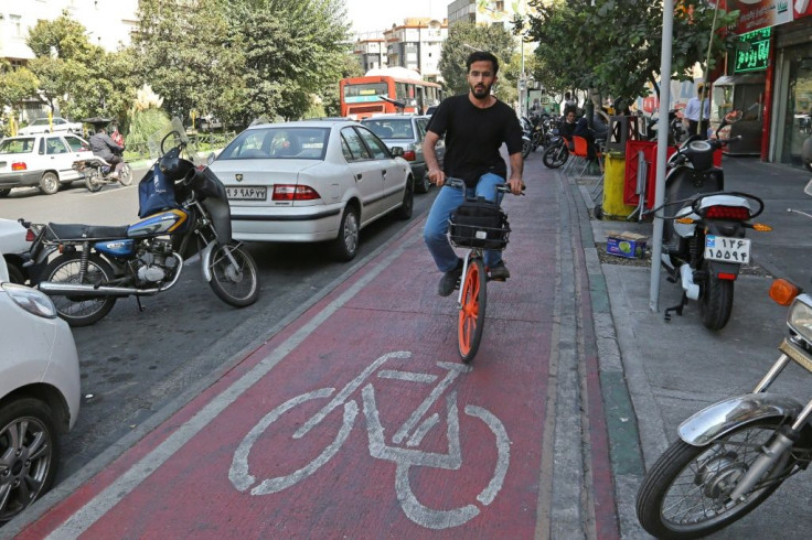 An Iranian man rides a bicyle from bike-sharing service Bdood in the capital Tehran