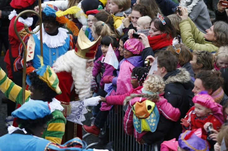 Sinterklaas (Saint Nicolas) and some men dressed as Zwarte Piet (Black Pete) parade in Groningen, Netherlands