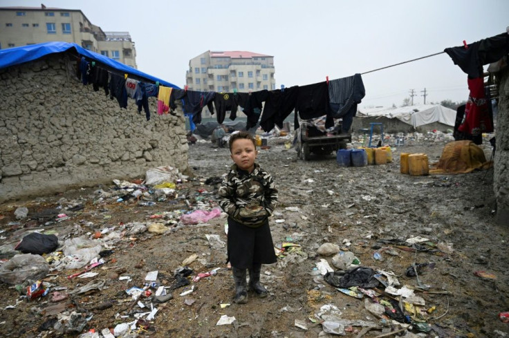An internally displaced Afghan boy in refugee camp in Kabul The Geneva conference issued 'a strong call for an immediate humanitarian ceasefire'