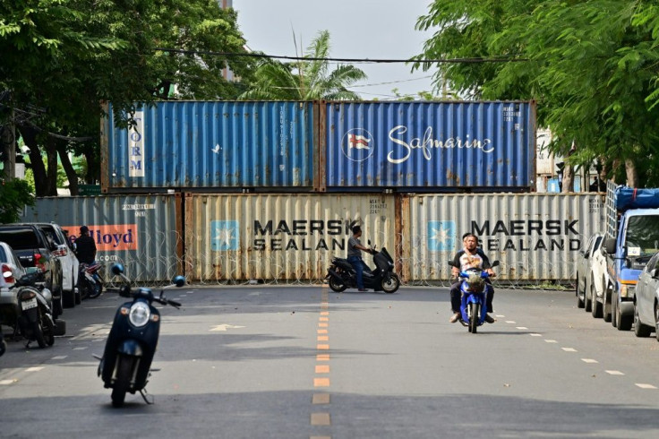 Police set up shipping containers near the Crown Property Bureau in Bangkok, before protest leaders switched the location of the rally
